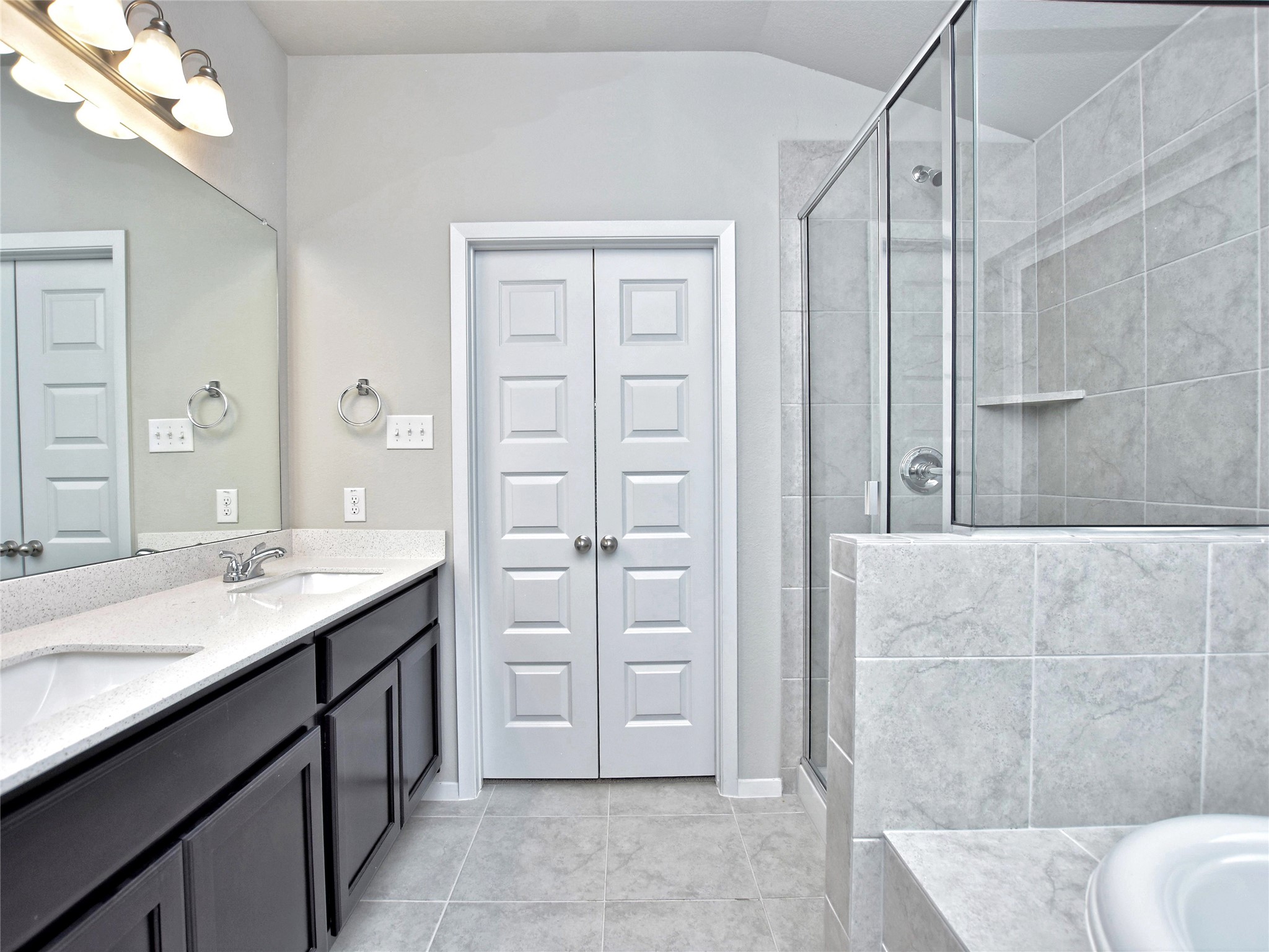 20701 Boggy Ford Road Lago Vista, TX 78645 - Photo 21 of 40 Bathroom featuring double vanity, a stall shower, light tile patterned floors, and a garden tub