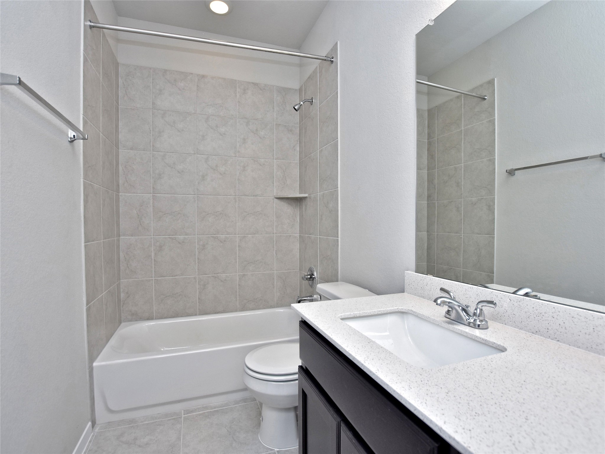 20701 Boggy Ford Road Lago Vista, TX 78645 - Photo 24 of 40 Bathroom featuring vanity, shower / tub combination, light tile patterned floors, and a textured wall