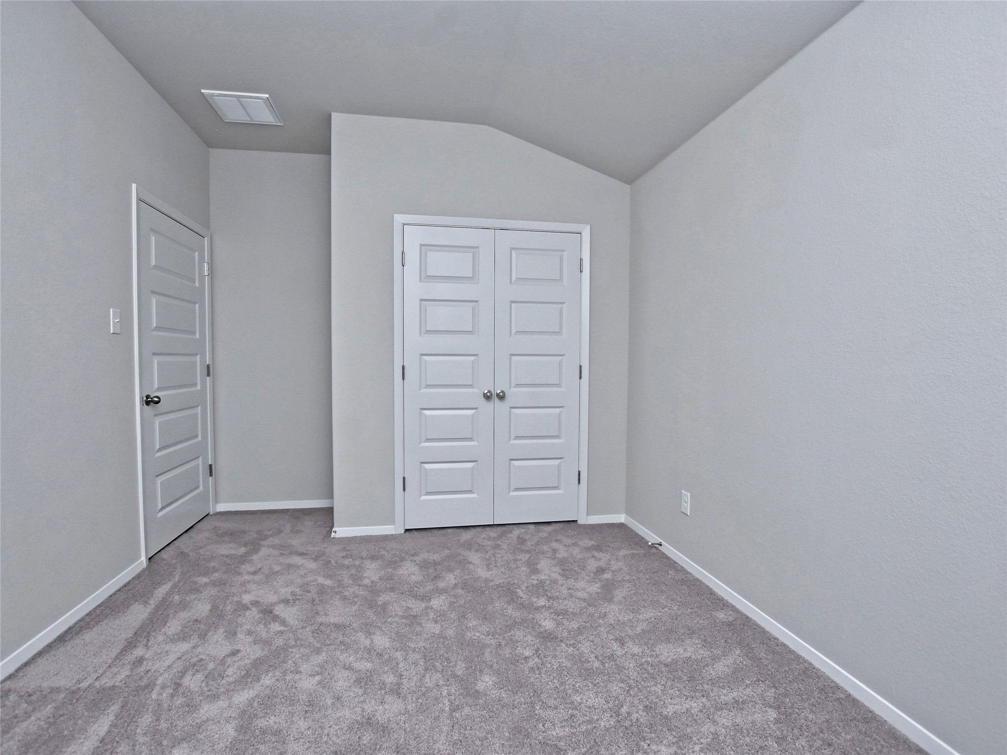 20701 Boggy Ford Road Lago Vista, TX 78645 - Photo 26 of 40 Unfurnished bedroom featuring light carpet, a closet, and lofted ceiling