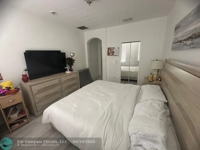 a bedroom with a bed and a television