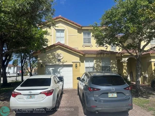 a view of a car parked in front of a house