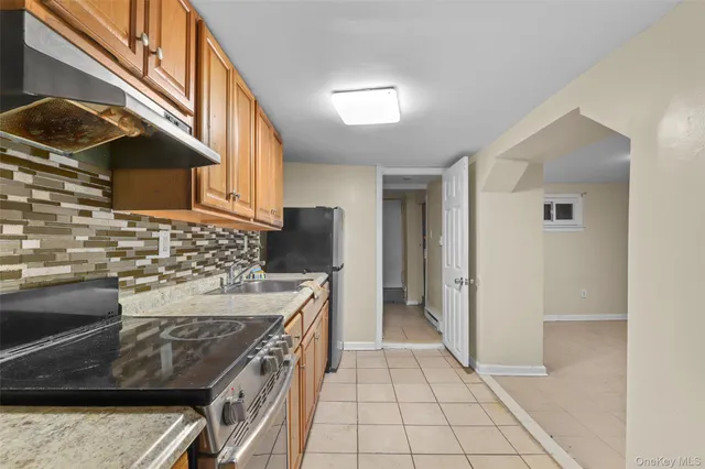 a kitchen with a stove a refrigerator and cabinets