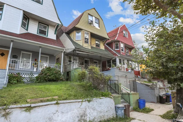 a view of a porch with wooden floor and iron stairs