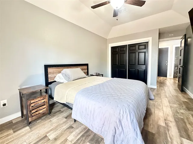 a bedroom with a bed and a large mirror