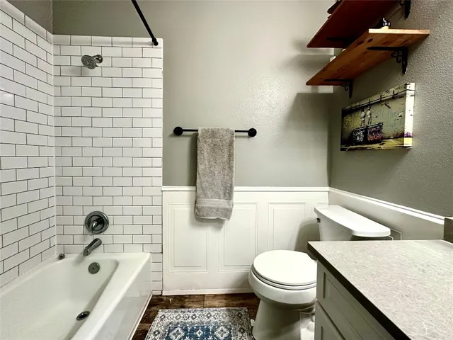 a bathroom with a sink a toilet and bathtub