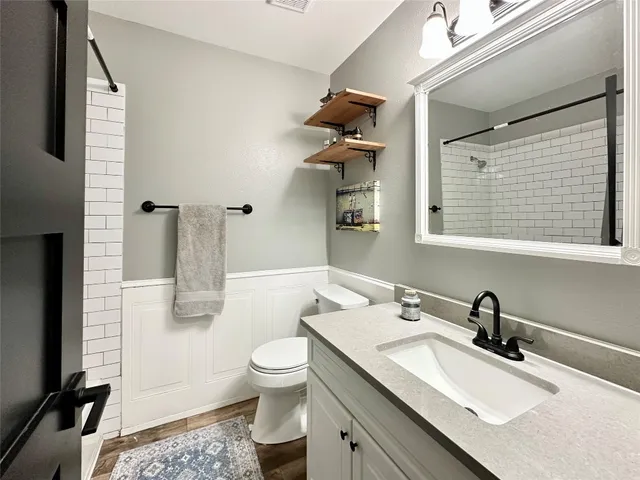 a bathroom with a sink toilet and shower