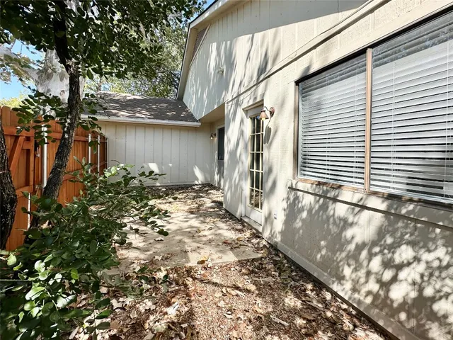 a view of a pathway of a house with a yard