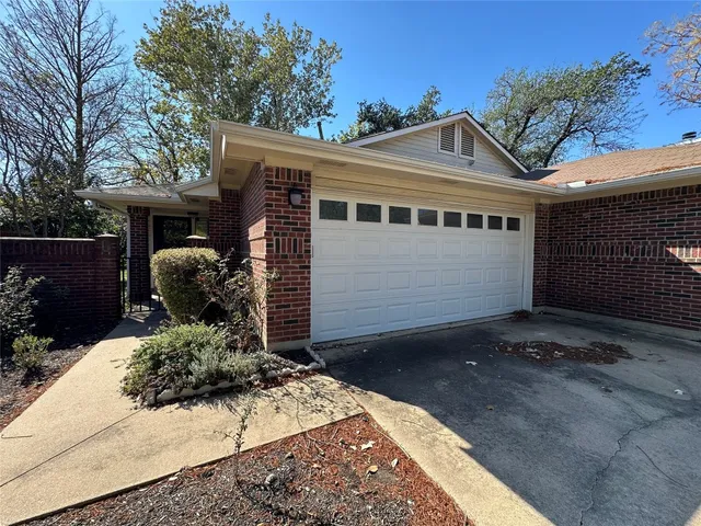 a view of a house with a yard and garage