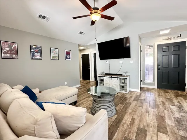 a living room with furniture and a flat screen tv