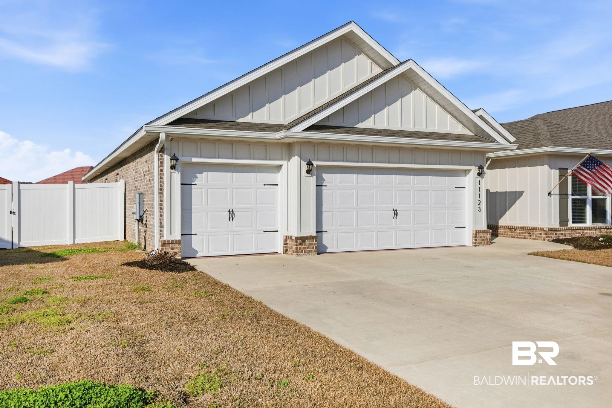 11123 Genuine Risk Circle Daphne, AL 36526 - Photo 4 of 67 View of front of home featuring board and batten siding, brick siding, driveway, and a garage