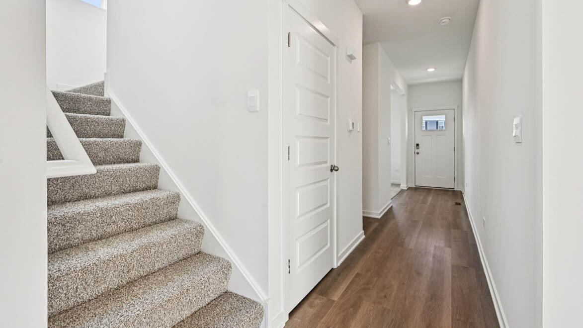 10365 Blaine Street Crown Point, IN 46307 - Photo 15 of 51 a view of a hallway with wooden floor and staircase