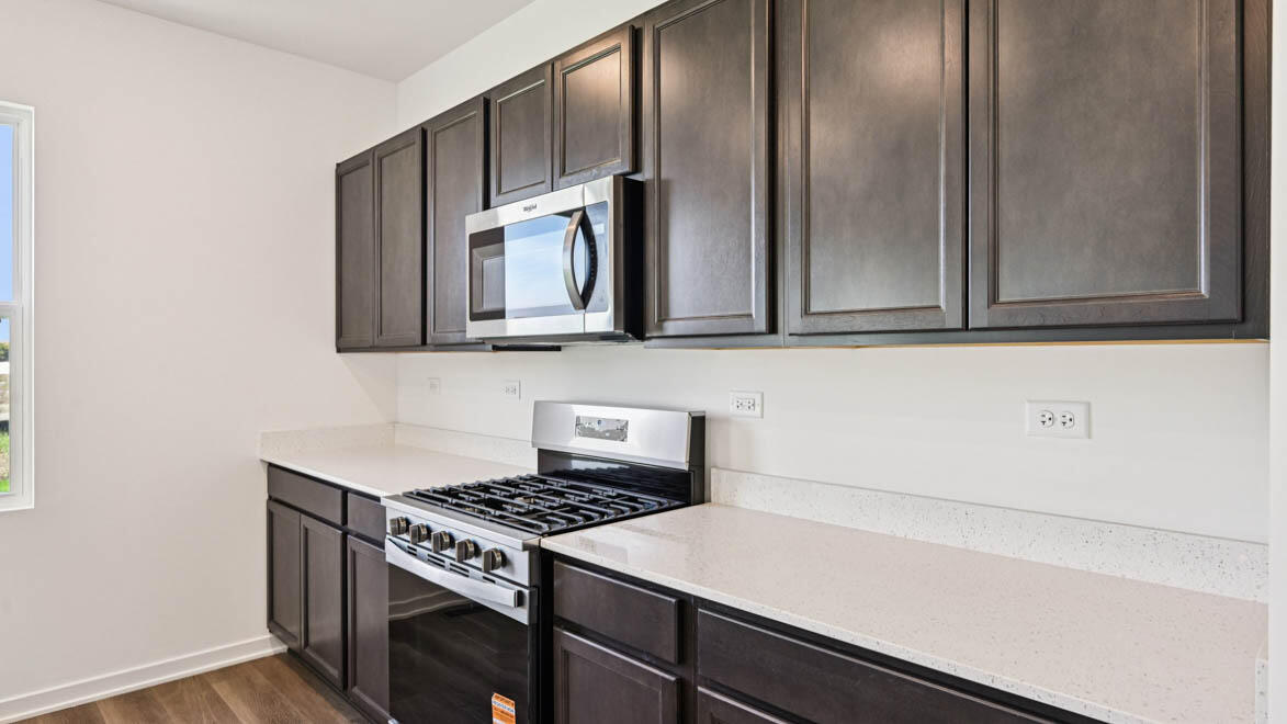 10365 Blaine Street Crown Point, IN 46307 - Photo 9 of 51 a kitchen with a stove and a microwave
