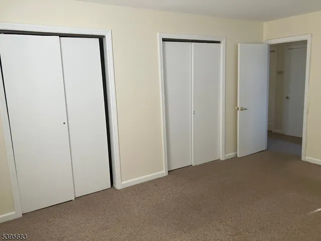 an empty room with closet area