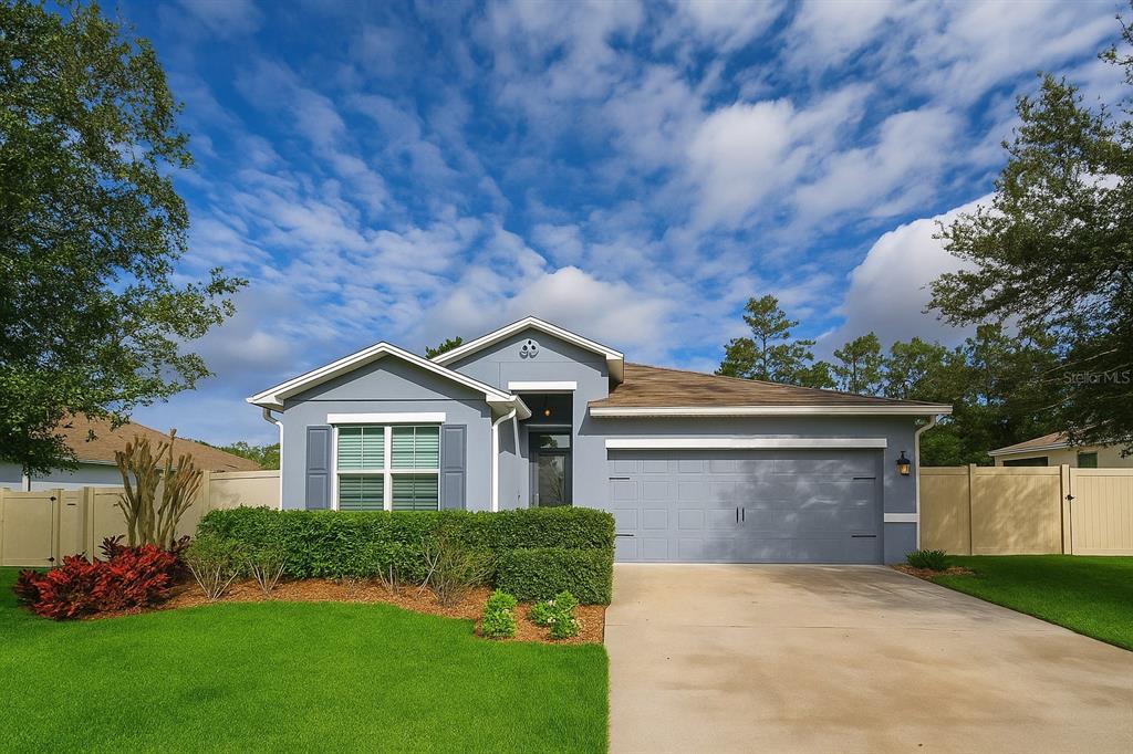 206 Wood Hollow Road DeLand, FL 32724 - Photo 1 of 1 a front view of a house with a yard and garage