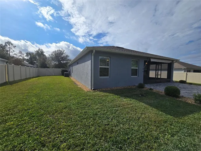 a backyard of a house with lots of green space