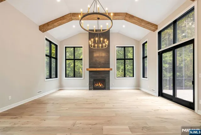 a view of an empty room with a fireplace and a window