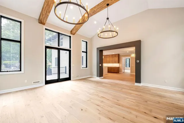 a view of a room with wooden floor and window