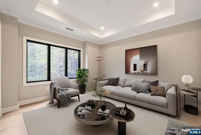 a living room with furniture a rug and a large window