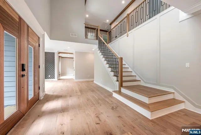 a view of entryway and hall with wooden floor