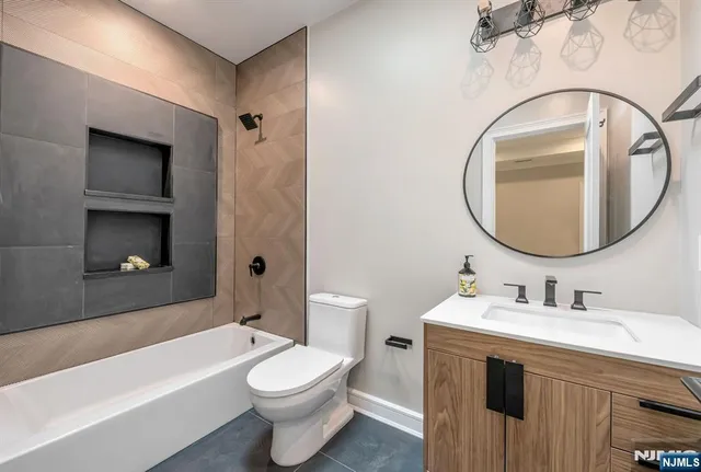 a bathroom with a sink a toilet and a mirror