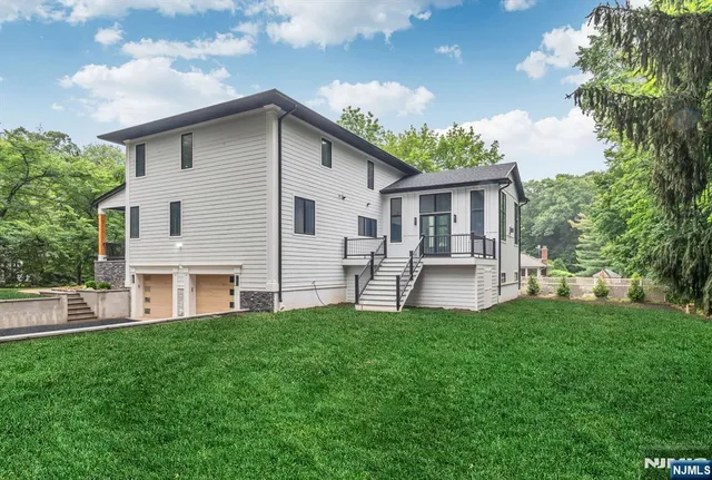 a view of a house with a yard and sitting area