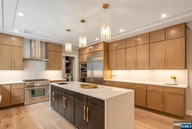 a kitchen with a sink a stove a refrigerator and a window