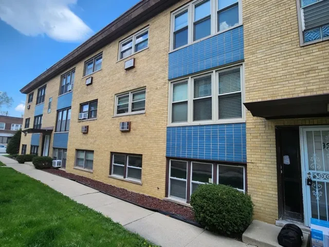 a view of a house with a yard and large windows