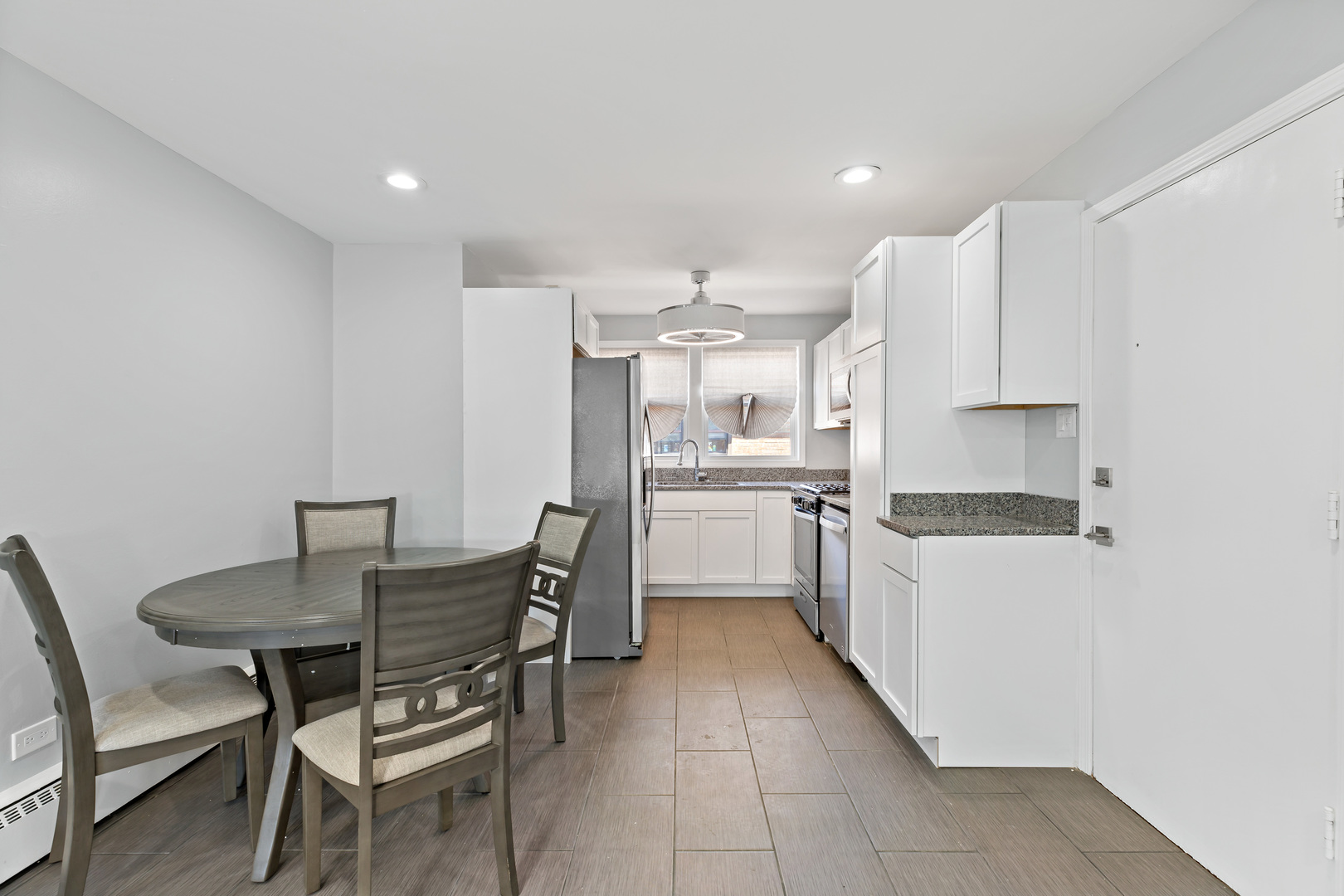 9211 South Cottage Grove Avenue, Unit 9C2 Chicago, IL 60619 - Photo 3 of 9 a kitchen with granite countertop a sink cabinets and stainless steel appliances