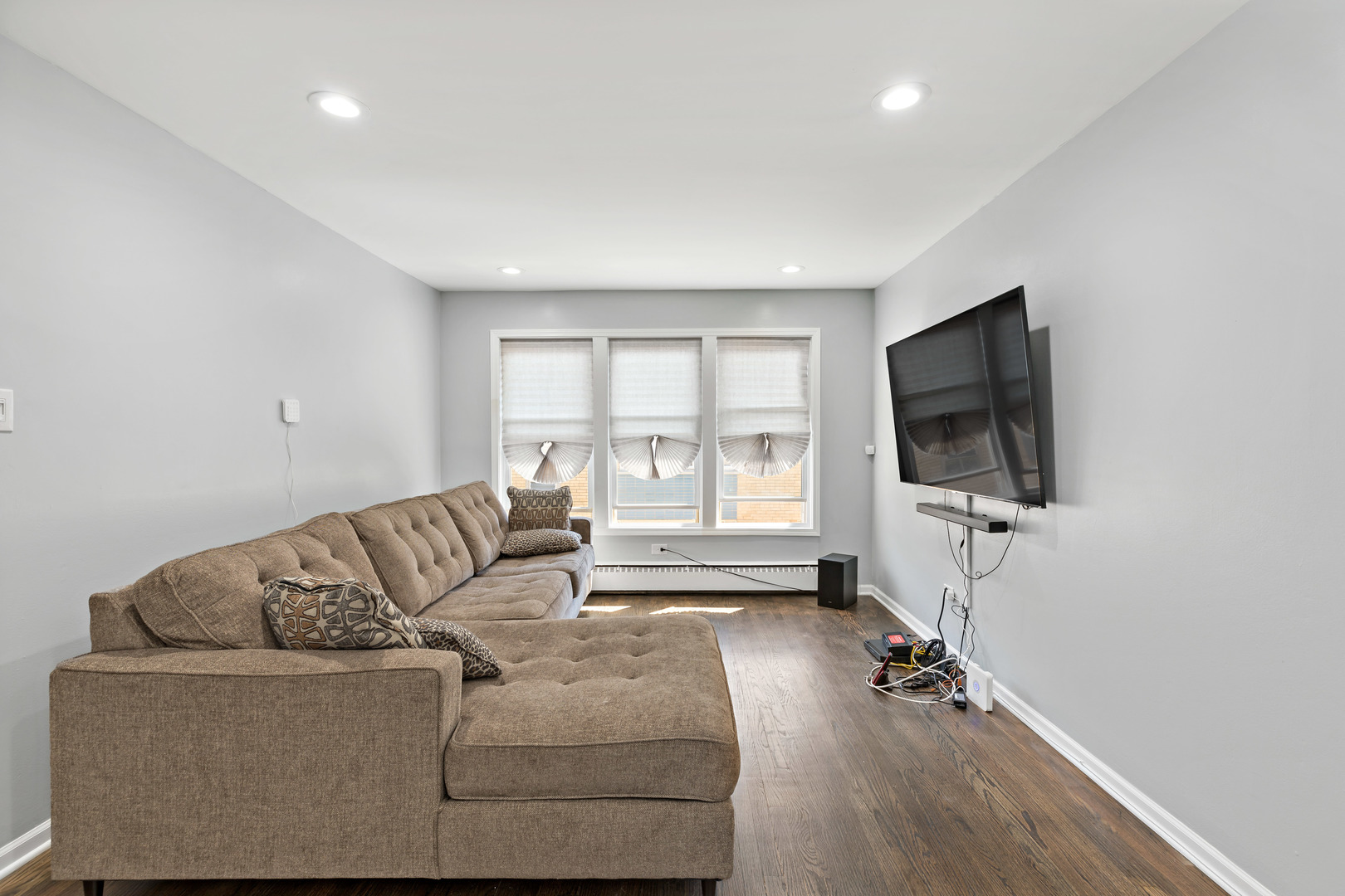 9211 South Cottage Grove Avenue, Unit 9C2 Chicago, IL 60619 - Photo 4 of 9 a living room with furniture and a flat screen tv