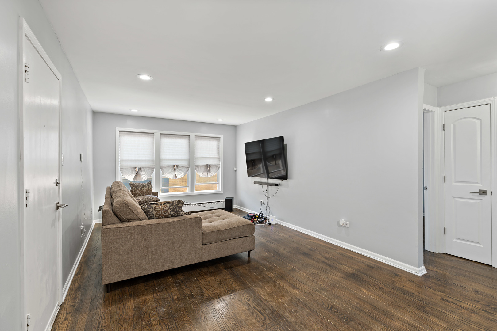 9211 South Cottage Grove Avenue, Unit 9C2 Chicago, IL 60619 - Photo 5 of 9 a living room with furniture and a flat screen tv