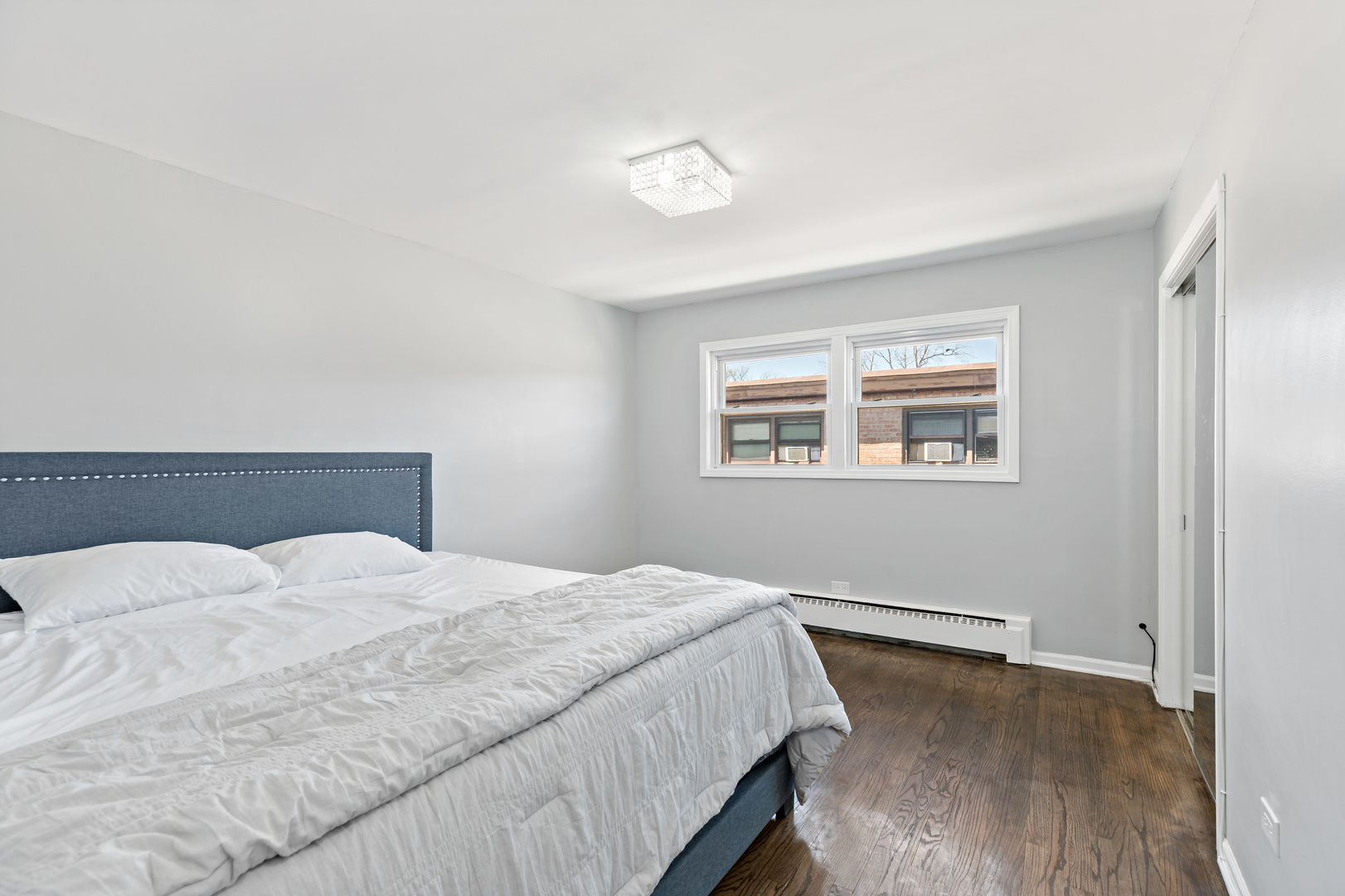 9211 South Cottage Grove Avenue, Unit 9C2 Chicago, IL 60619 - Photo 6 of 9 a bedroom with a bed and a window