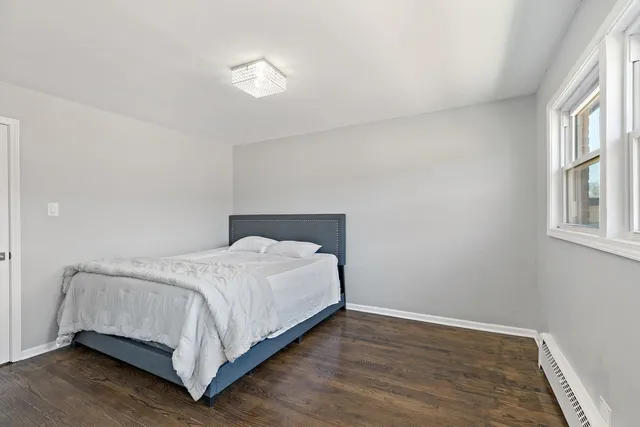 a bed sitting in a bedroom next to a window