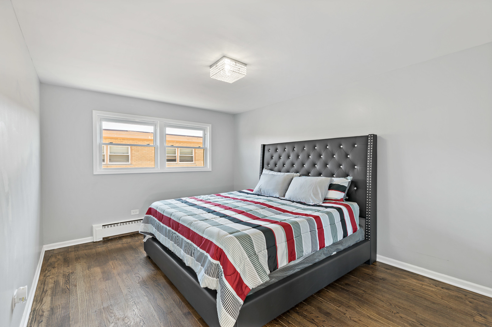 9211 South Cottage Grove Avenue, Unit 9C2 Chicago, IL 60619 - Photo 8 of 9 a bedroom with a bed and a window