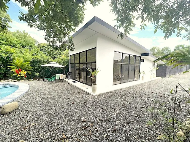 a view of a house with a yard and sitting area