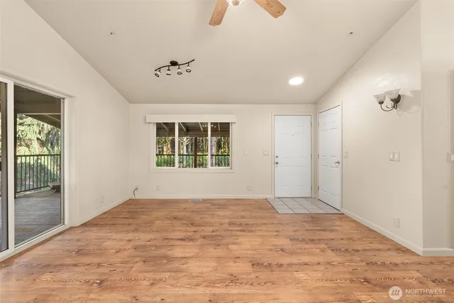 a view of a livingroom with furniture window and wooden floor