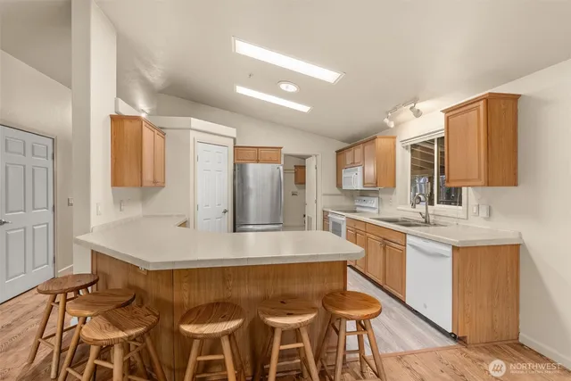a kitchen with a sink and a refrigerator