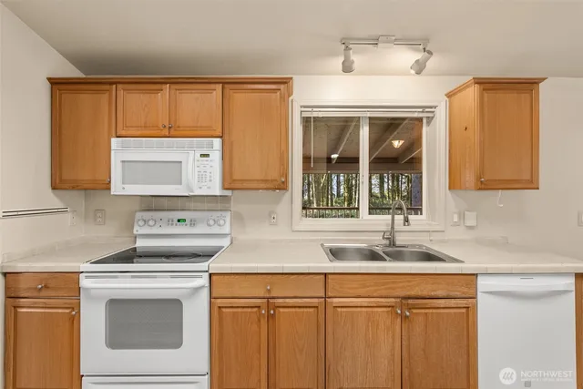a kitchen with a sink stove and cabinets