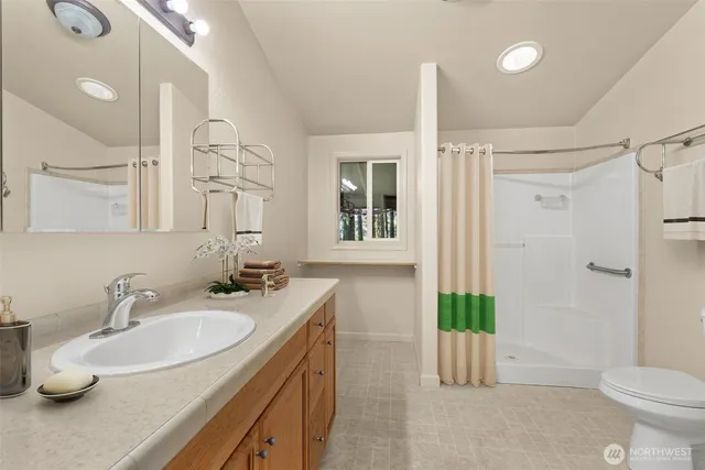 a bathroom with a sink toilet and shower