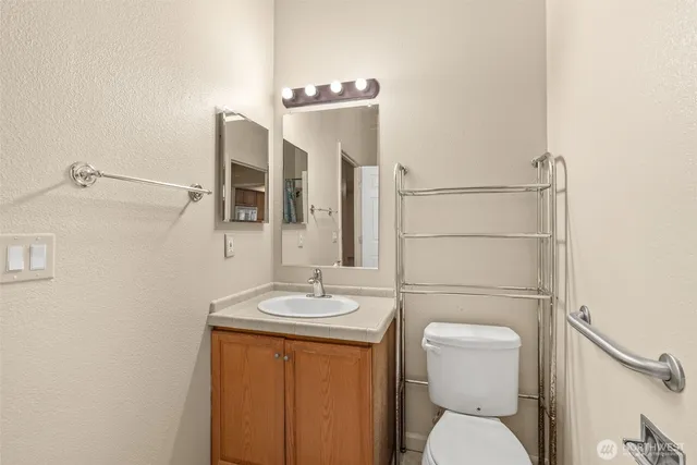 a bathroom with a tub sink and mirror