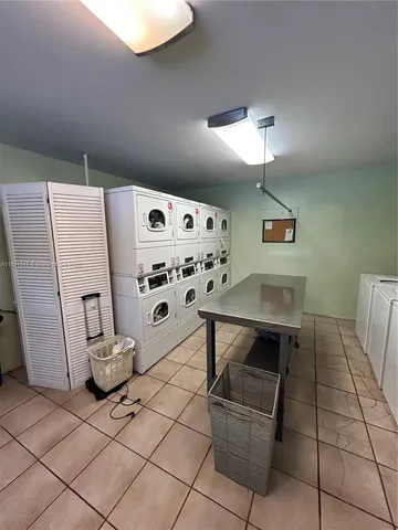 a room with furniture a washer and dryer