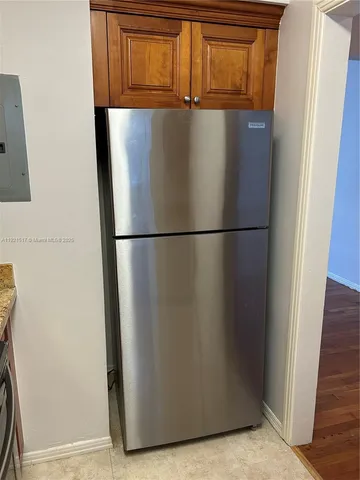 a view of a refrigerator in a kitchen