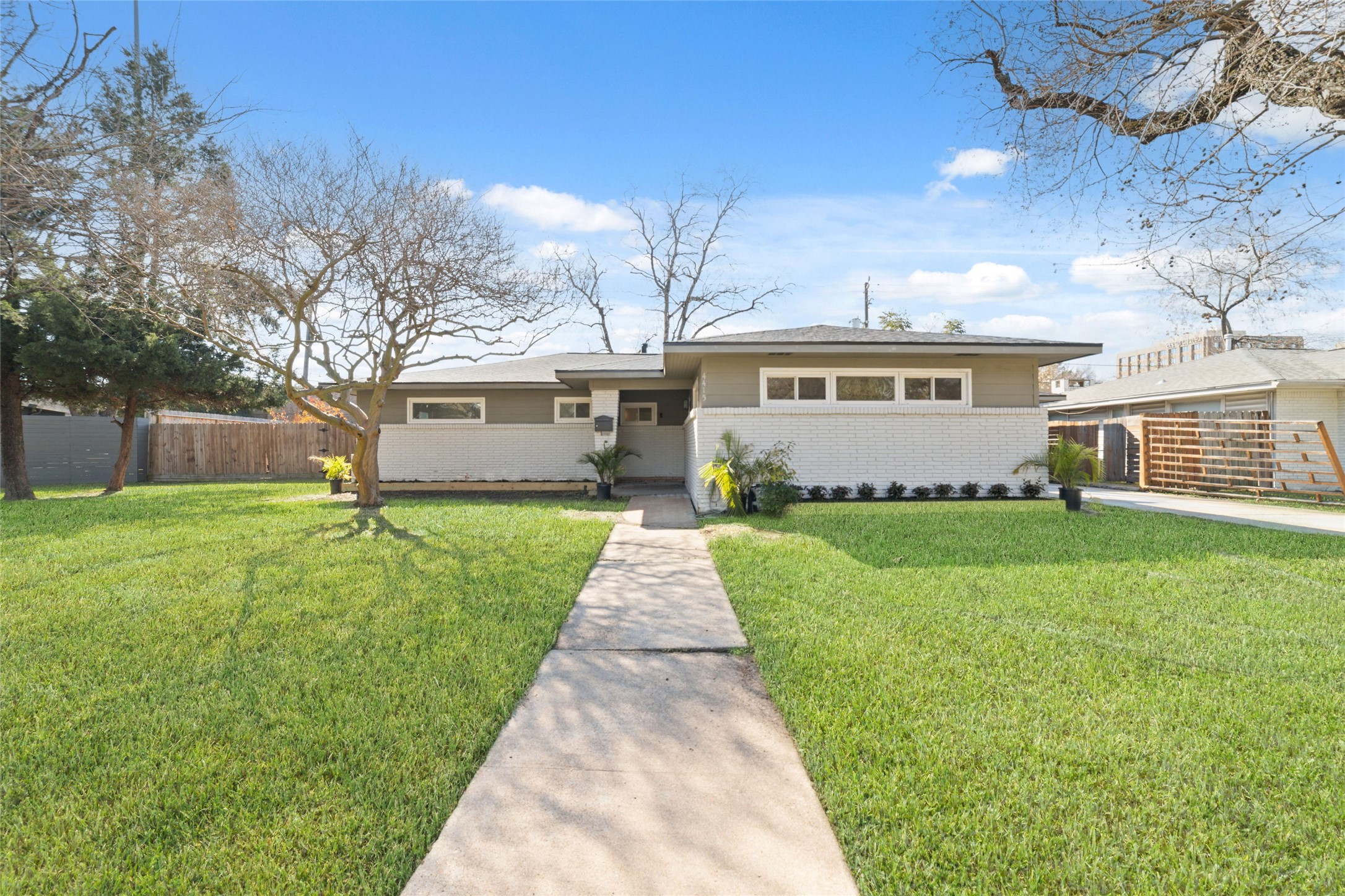 a front view of a house with a garden and yard