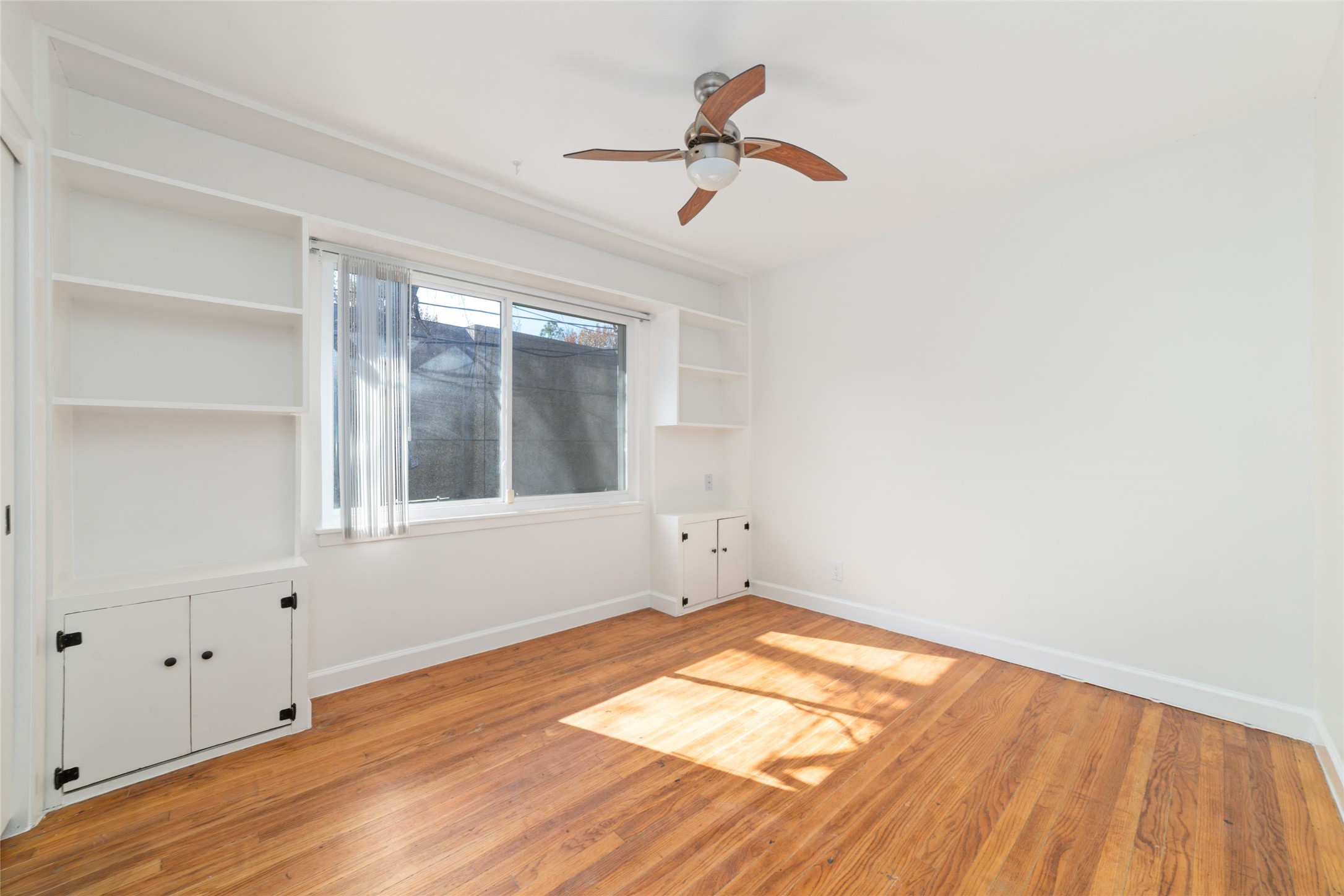 4415 Merwin Street Houston, TX 77027 - Photo 12 of 18 a view of empty room with wooden floor and fan