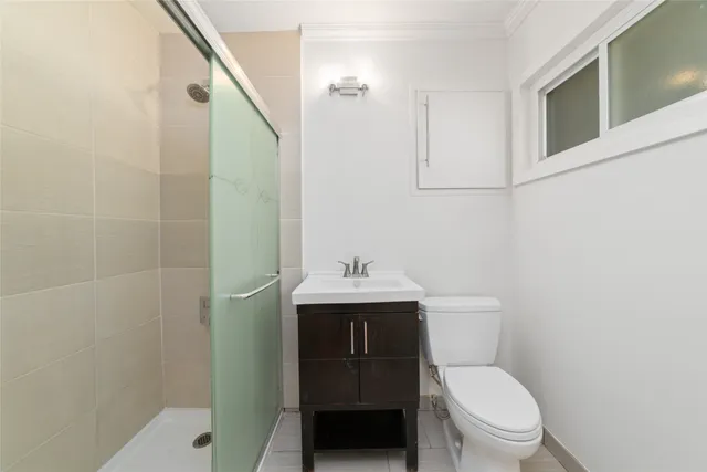 a bathroom with a toilet a sink and mirror