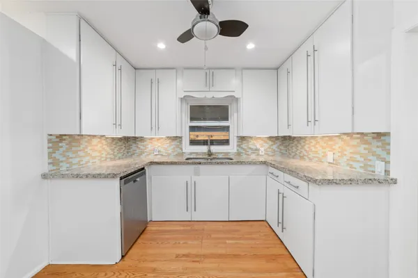 a kitchen with granite countertop cabinets stainless steel appliances and a sink