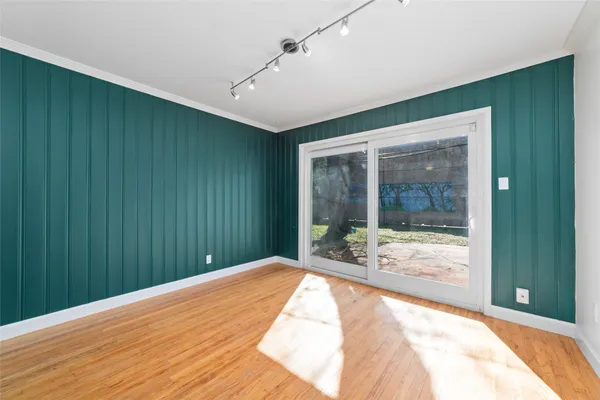 a view of a big room with wooden floor and windows