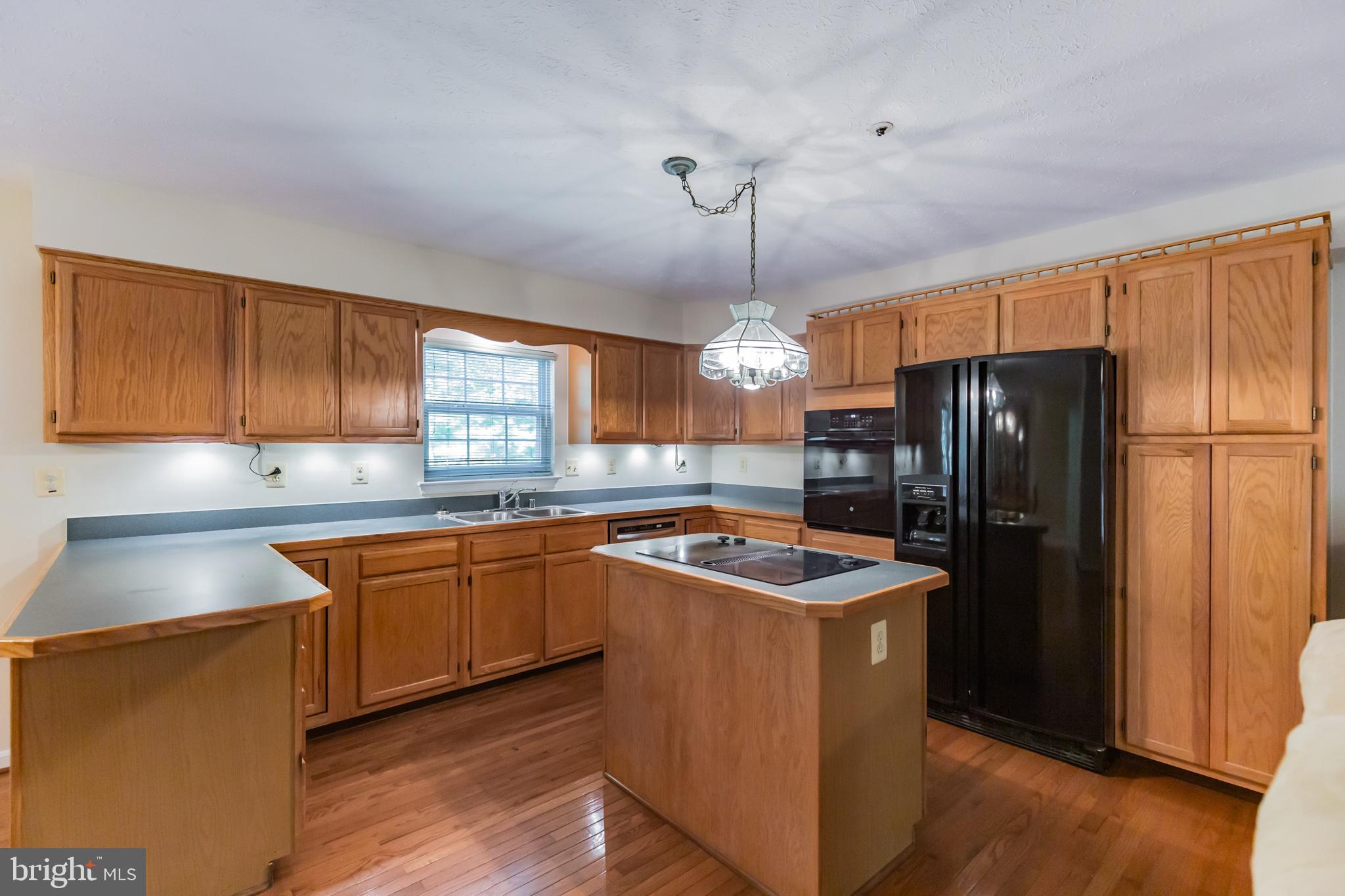 640 Small Reward Road Huntingtown, MD 20639 - Photo 6 of 28 a kitchen with stainless steel appliances granite countertop refrigerator sink and cabinets