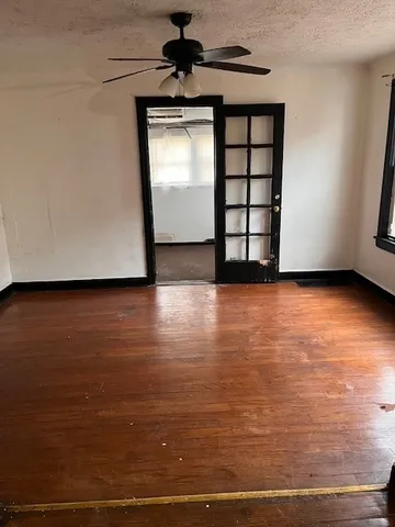 a view of a room with wooden floor and window