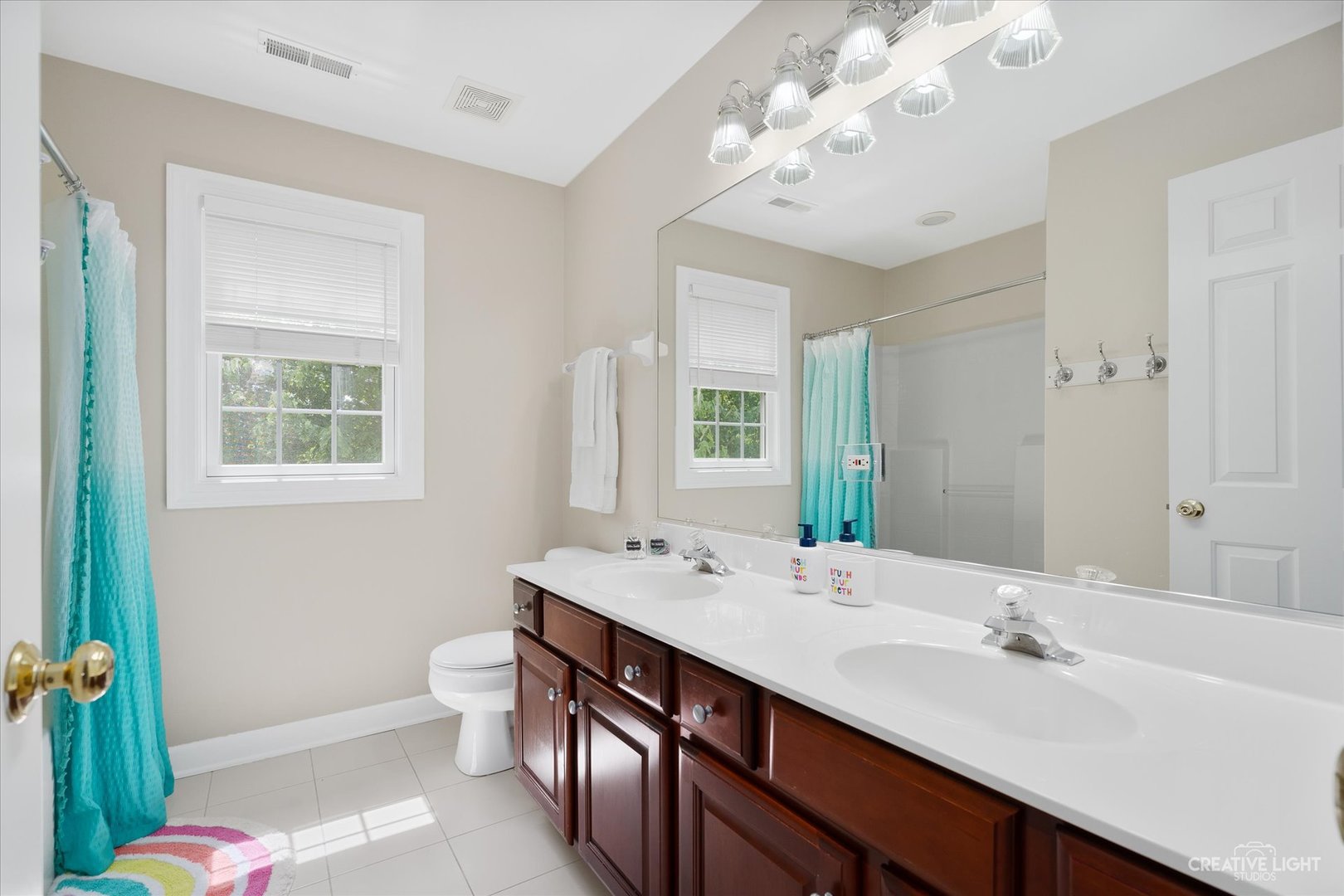 4N414 School Road St. Charles, IL 60175 - Photo 27 of 41 a bathroom with a double vanity sink mirror and toilet