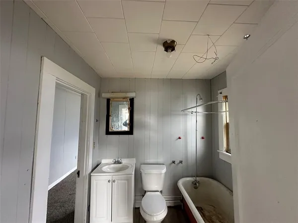 a bathroom with a toilet sink and mirror